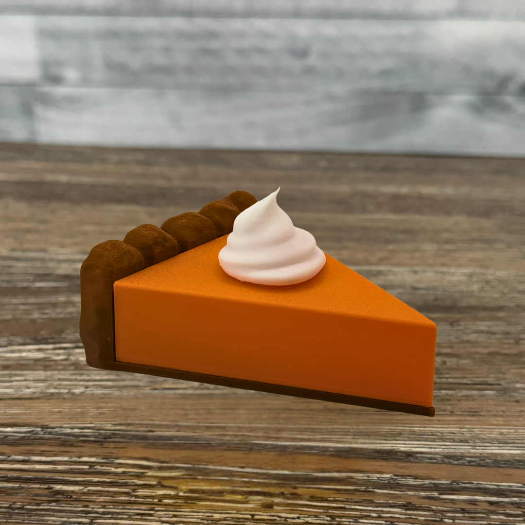 Side view of the pumpkin pie light sitting on a wooden dining room table as a centerpiece.